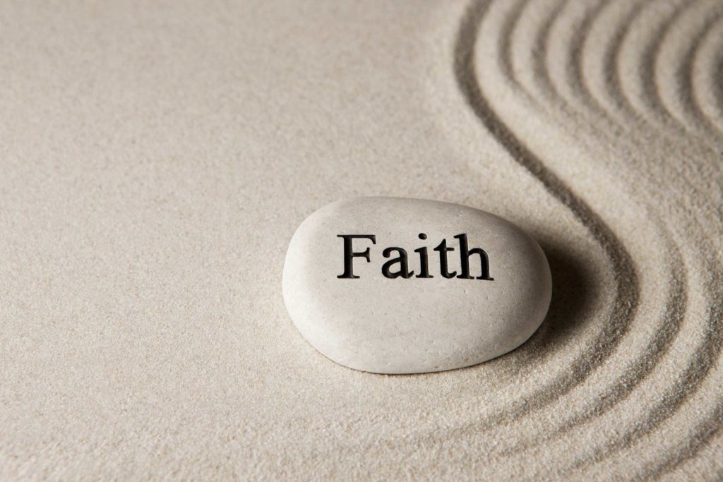 Stone with Faith written on it